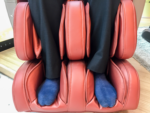 view of someones legs being massaged in an electric massage chair