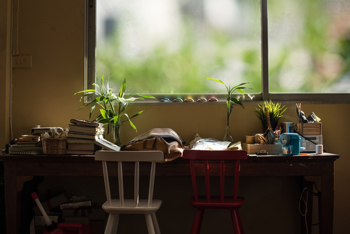 Clutter is scattered across a home desk
